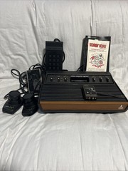 Atari 2600 Console Bundle W/ Pong Paddle, Touch Pad, Cords, and Manuals Untested