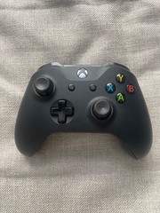 Black Microsoft Xbox One X 1TB Home Console. 2 controllers, console, power cord.