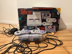 Super Nintendo Console with box and two games, two controllers & manual