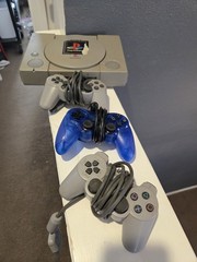 Sony PlayStation Gray Console With Three Controllers And Cords