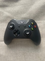 Black Microsoft Xbox One X 1TB Home Console. 2 controllers, console, power cord.